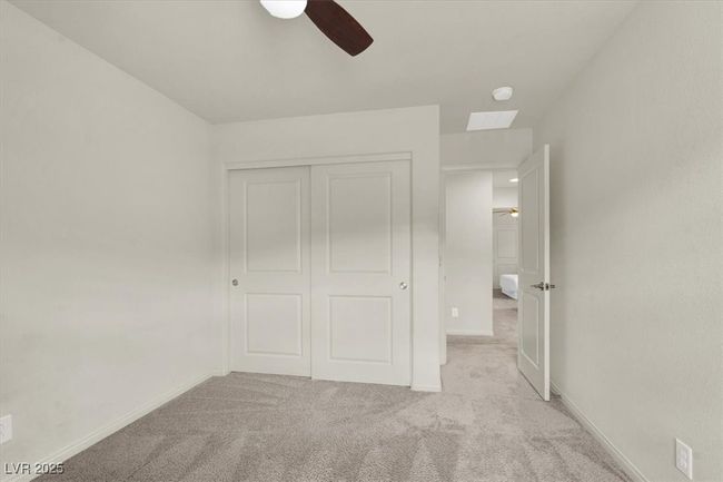 Unfurnished bedroom with light carpet, a closet, and a ceiling fan | Image 47