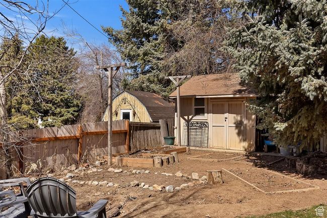 View of yard with fence, a shed, and an outbuilding | Image 34