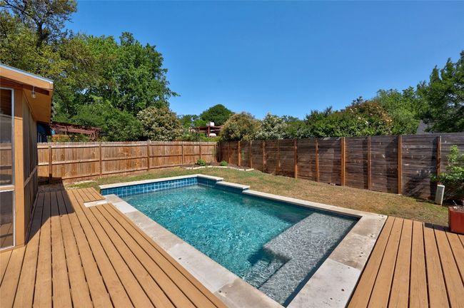 View of pool featuring a fenced backyard and a wooden deck | Image 29