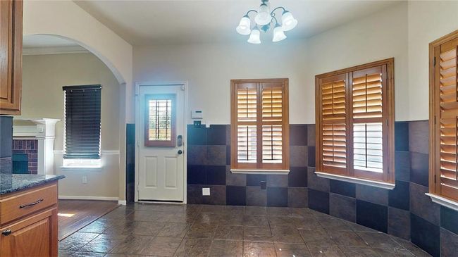 Elegant gourmet kitchen with cozy dining nook. | Image 13