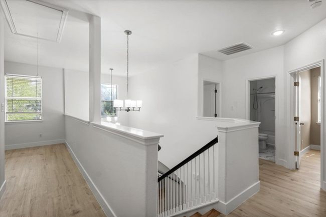 Hallway featuring attic access, an upstairs landing, plenty of natural light, and light wood-type flooring | Image 24