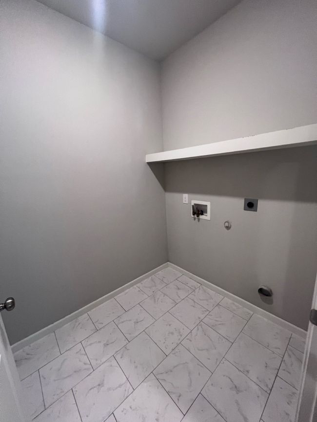 Washroom with electric dryer hookup, light marble finish floors, hookup for a gas dryer, and baseboards | Image 4