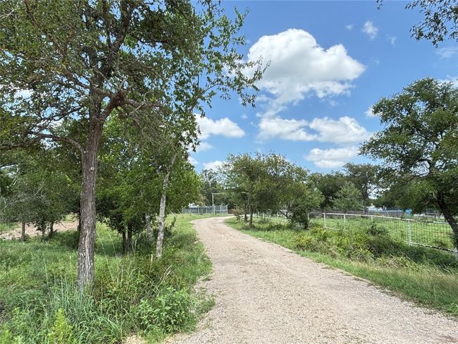View of dirt / gravel road with a view of rural / pastoral area | Image 4