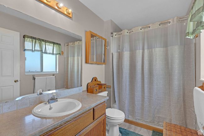 Bathroom with vanity, toilet, and shower / tub combo with curtain | Image 15