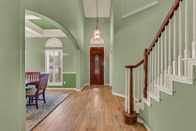 Foyer entrance with hardwood / wood-style flooring, arched walkways, and stairway | Image 4