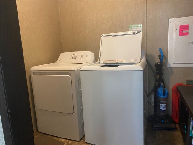 Laundry area with electric panel and independent washer and dryer | Image 9