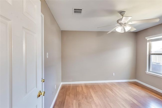 Empty room with a ceiling fan and light wood-type flooring | Image 24