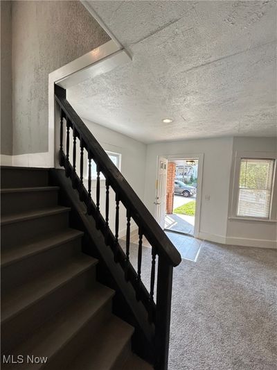 Stairs featuring carpet and a textured ceiling | Image 3