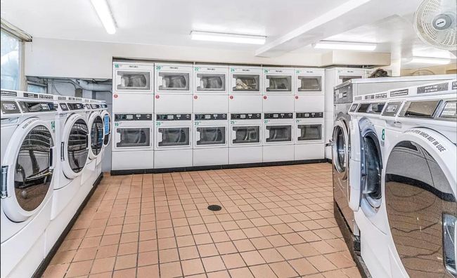 Community laundry featuring separate washer and dryer, stacked washer / drying machine, and light tile patterned floors | Image 10