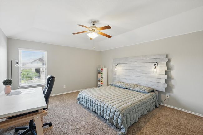 Carpeted bedroom featuring baseboards and a ceiling fan | Image 24