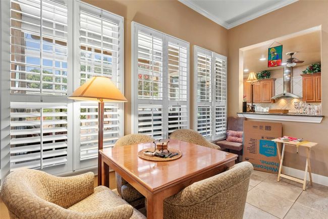 Dining space featuring ornamental molding and light tile patterned floors | Image 5