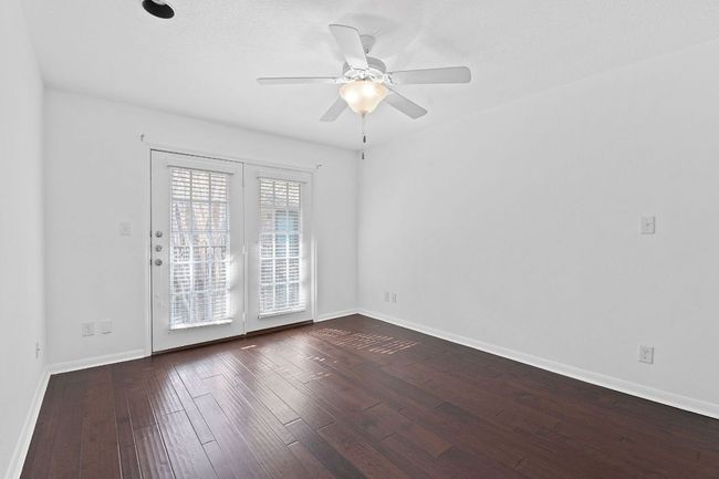 Empty room with baseboards, dark wood-style flooring, and ceiling fan | Image 19