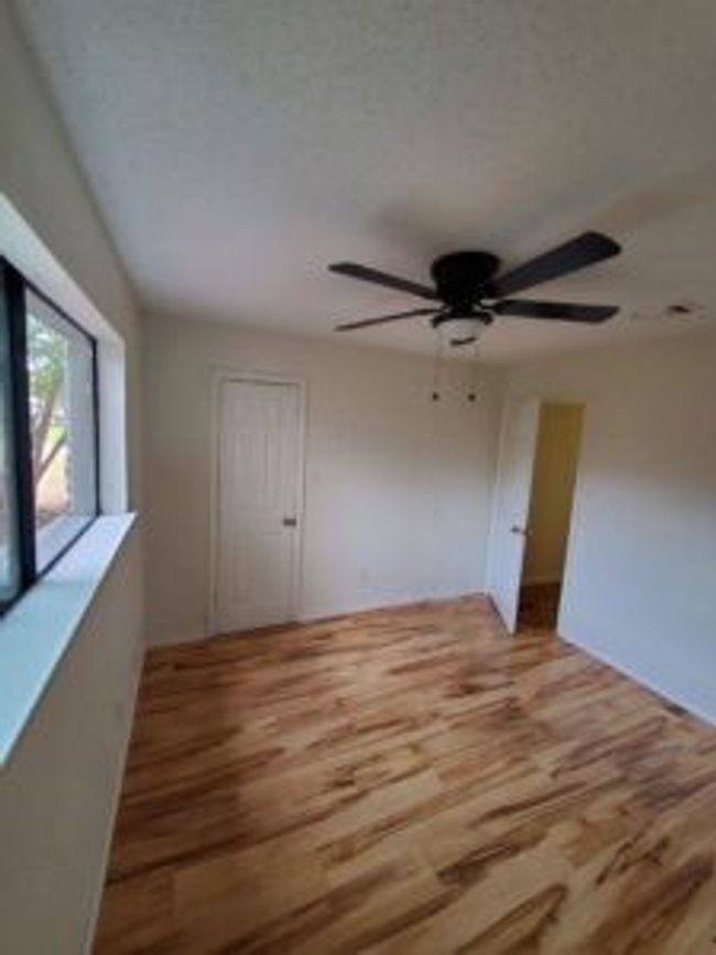 Empty room with wood finished floors and ceiling fan | Image 25