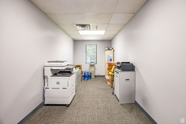Office area with a drop ceiling and carpet flooring | Image 16
