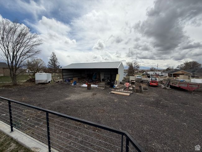 View of vehicle parking with an outbuilding and fence | Image 31