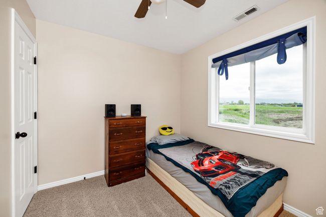 Bedroom with baseboards, carpet, and a ceiling fan | Image 15