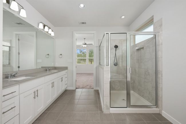 Bathroom with tile patterned floors, double vanity, a stall shower, ceiling fan, and recessed lighting | Image 19