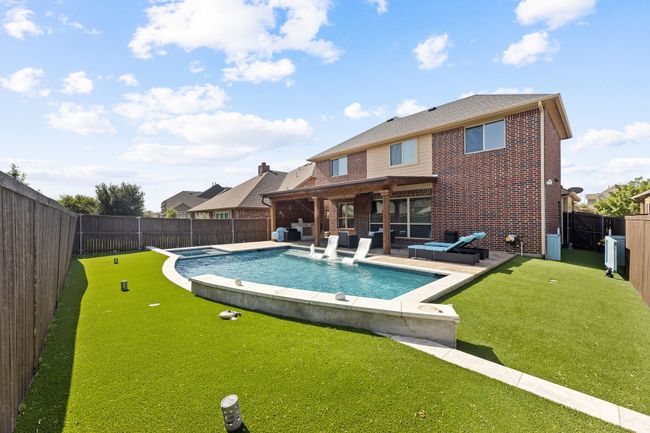 View of pool featuring a fenced backyard, a pool with connected hot tub, and a patio area | Image 27