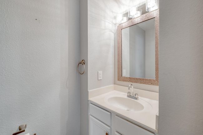 Bathroom with vanity and a textured wall | Image 14