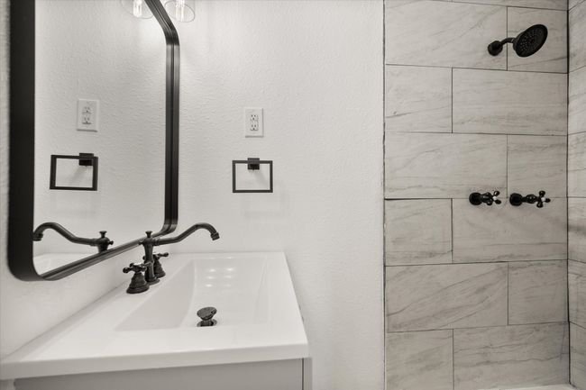 Bathroom with tiled shower and vanity | Image 11