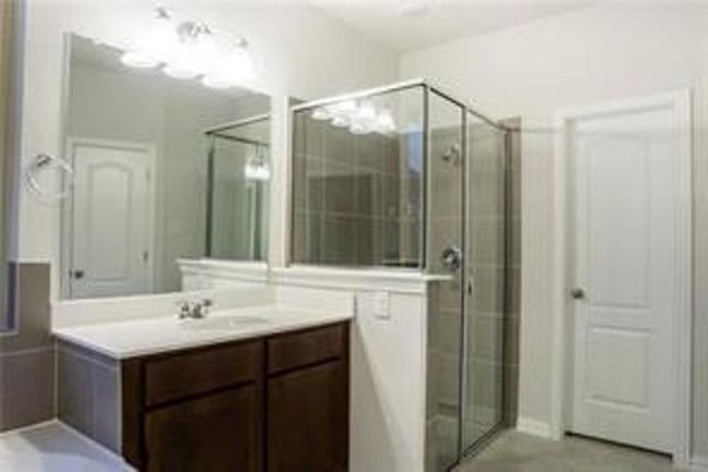 Bathroom featuring vanity, a shower stall, and a bathtub | Image 21