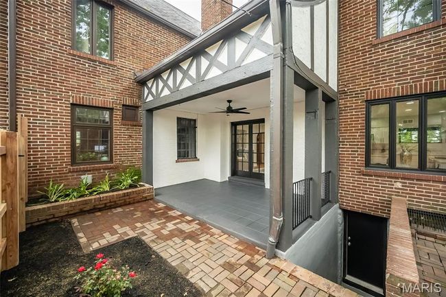 Entrance to property with brick siding, a ceiling fan, french doors, and a chimney | Image 30