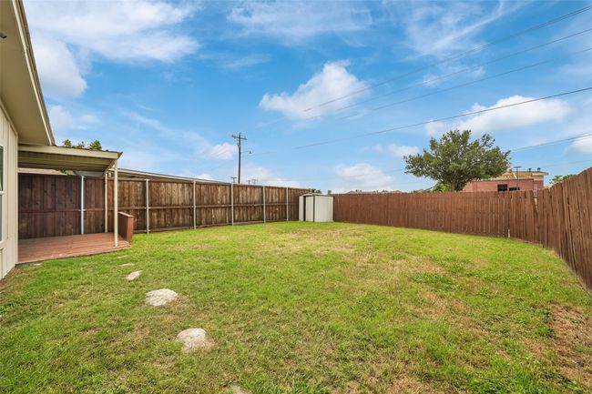 Fenced backyard with a shed | Image 27
