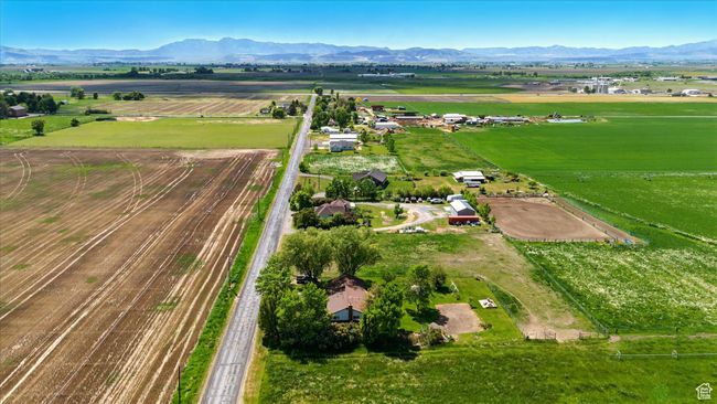Aerial view of sparsely populated area featuring a mountain backdrop and abundant farmland | Image 28