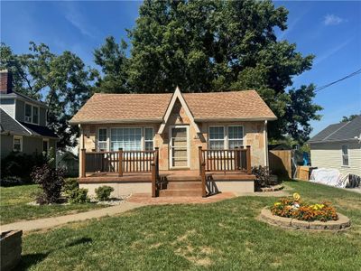 View of front facade featuring a storage unit and a front lawn | Image 1