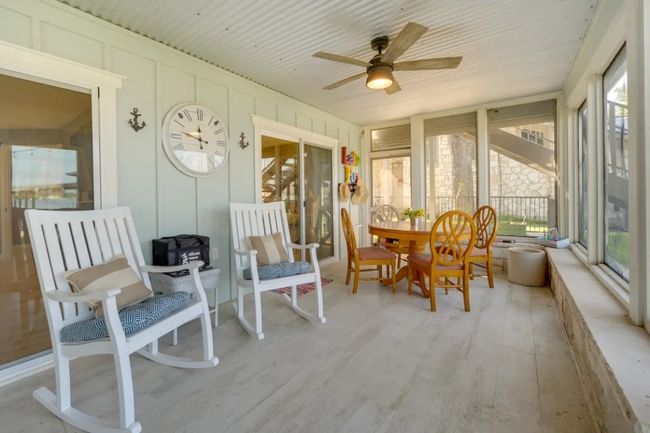 Sunroom / solarium with healthy amount of natural light, a ceiling fan, and outdoor dining space | Image 29