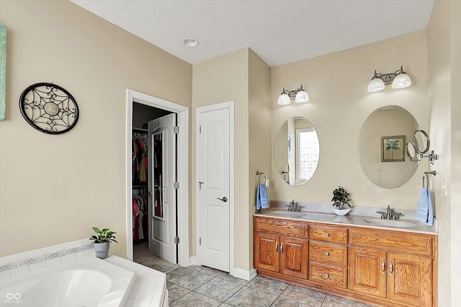 Primary Bedroom ensuite has double sinks, garden tub and step in shower. | Image 23