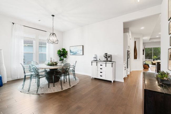 Dining space with dark wood finished floors and recessed lighting | Image 8