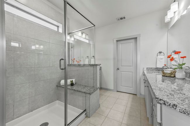 Bathroom featuring tile patterned flooring, vanity, and a shower with shower door | Image 26