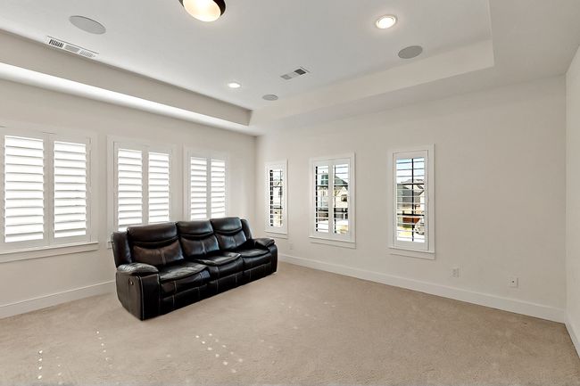 Living room featuring baseboards, carpet flooring, a raised ceiling, and recessed lighting | Image 16