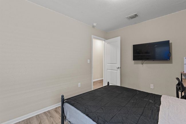 Bedroom with wood finished floors and baseboards | Image 19