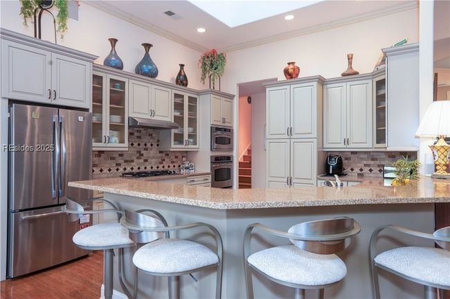 Lovely updated Kitchen cabinets with Dacor gas cooktop and vent, GE Profile Convection oven and Microwave Convection Oven. | Image 23