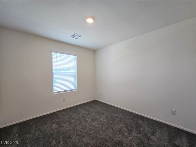Unfurnished room with dark carpet and baseboards | Image 19