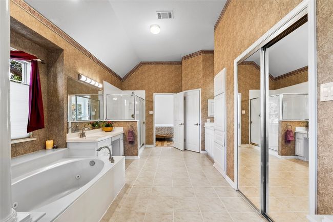 With neutral tones and refined finishes, the ensuite bath creates a serene atmosphere, making it a perfect place to refresh and recharge | Image 23
