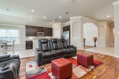 Living room with light wood-type flooring and ornamental molding | Image 2