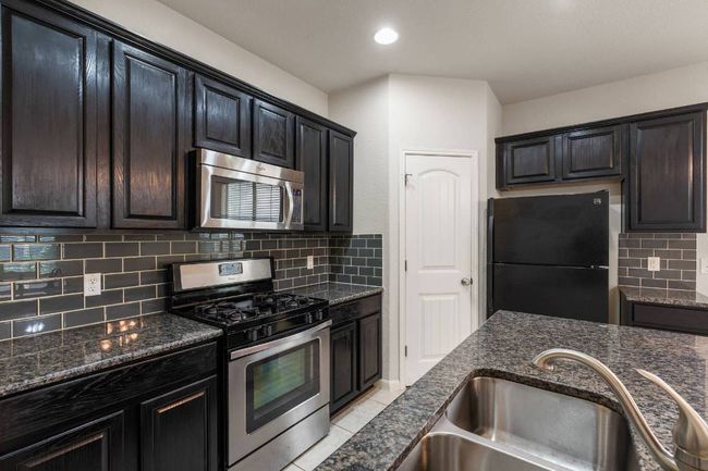 Walk-in pantry next to the refrigerator. | Image 18