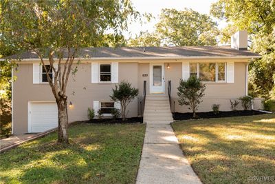 View of front facade with a garage and a front lawn | Image 2