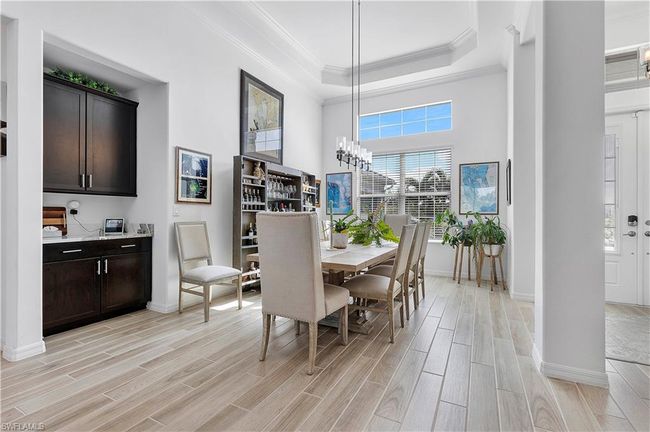 Dining room featuring crown molding, baseboards, and wood tiled floors | Image 31