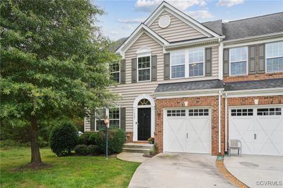 View of front of house with a front lawn and a garage | Image 1