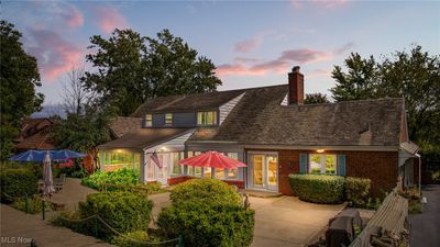 The stunning patio features elegant seating that overlooks a vibrant garden and sparkling pool. Surrounded by lush greenery, it offers complete privacy, creating a serene retreat for relaxation or entertaining. | Image 3