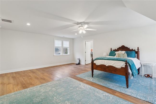 Bedroom featuring visible vents, wood finished floors, recessed lighting, baseboards, and ceiling fan | Image 37