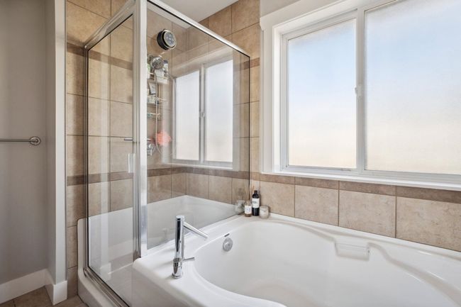 Full bathroom featuring a shower stall and a bath | Image 21