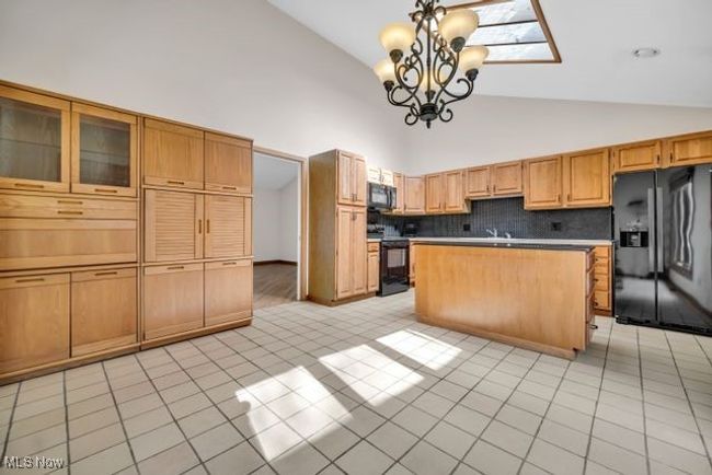 Kitchen with center island, skylight, large eating area and an extra bank of kitchen cabinets which are removable | Image 15