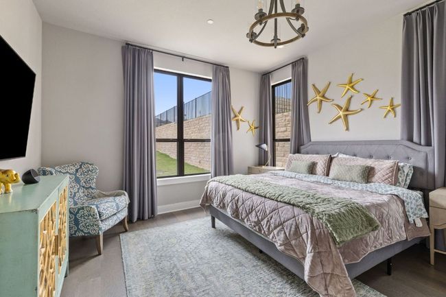 Bedroom with a chandelier, wood finished floors, and baseboards | Image 23