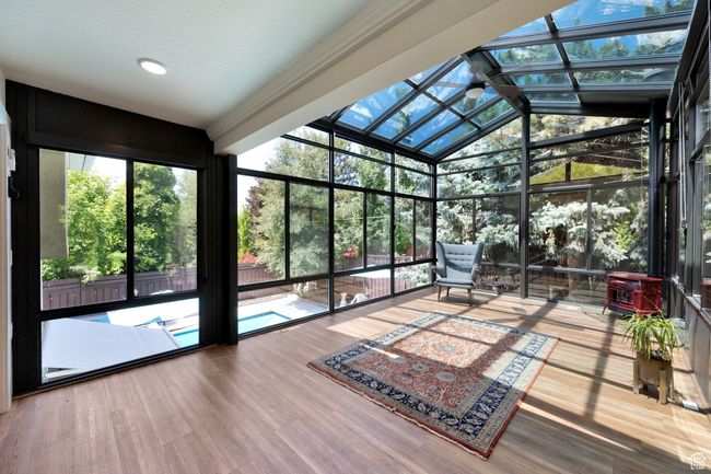 Sunroom / solarium featuring vaulted ceiling | Image 25