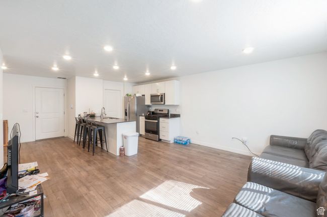 Living room with light wood-type flooring and recessed lighting | Image 4